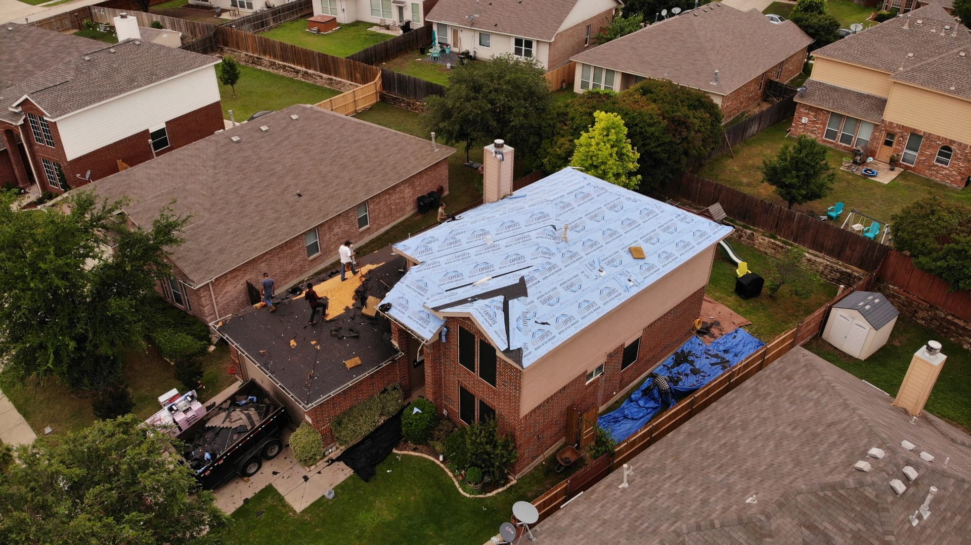 Licensed roofing crew installing underlayment